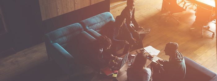 Startup Team Brainstorming in Meeting on Couch in Loft Office