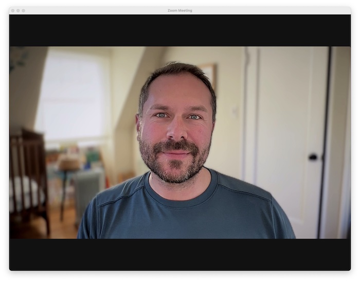 A screenshot of a face during a Zoom call taken with the high-quality Apple iPhone 13 with Continuity Camera